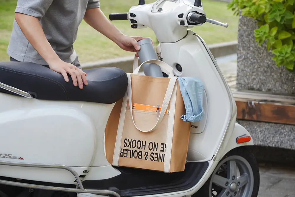 Chia Huang Circular Creative Kraft Paper Tote Bag | Scooter Commute Shot